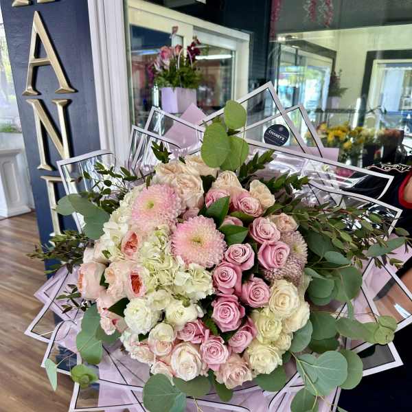 Large bouquet of pink and cream roses with eucalyptus