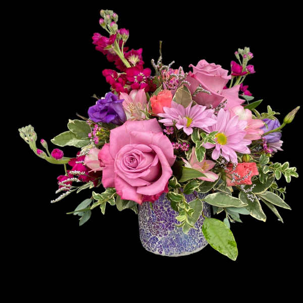 Pink and purple mixed flower arrangement in a mosaic vase