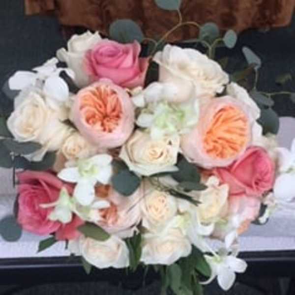 Bouquet of pink, white, and peach roses with white orchids