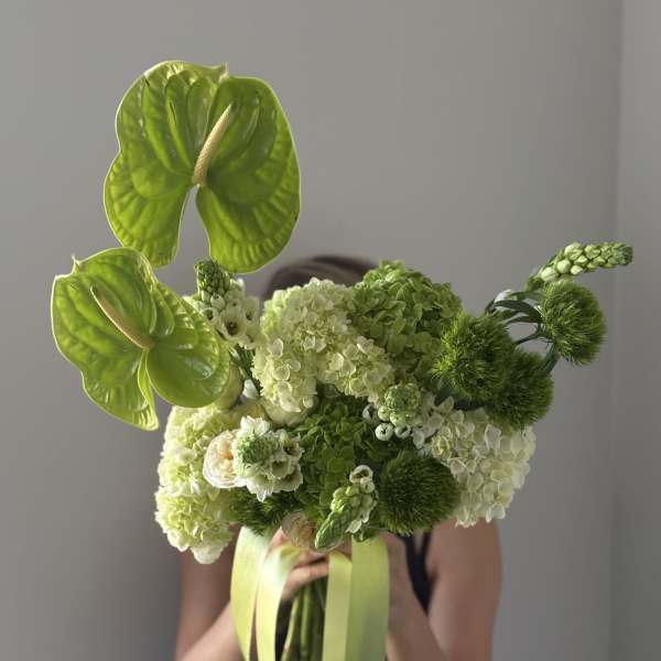 Bouquet of green anthuriums and hydrangeas with ribbon