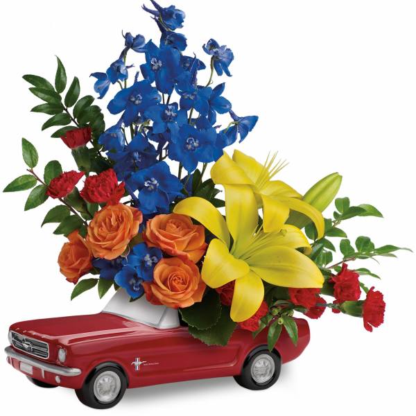 Flowers arranged in a red toy car container