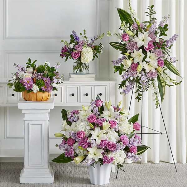 Floral arrangements with pink roses, white lilies, and lavender blooms