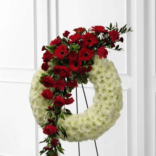 Red and white floral wreath on a standing easel