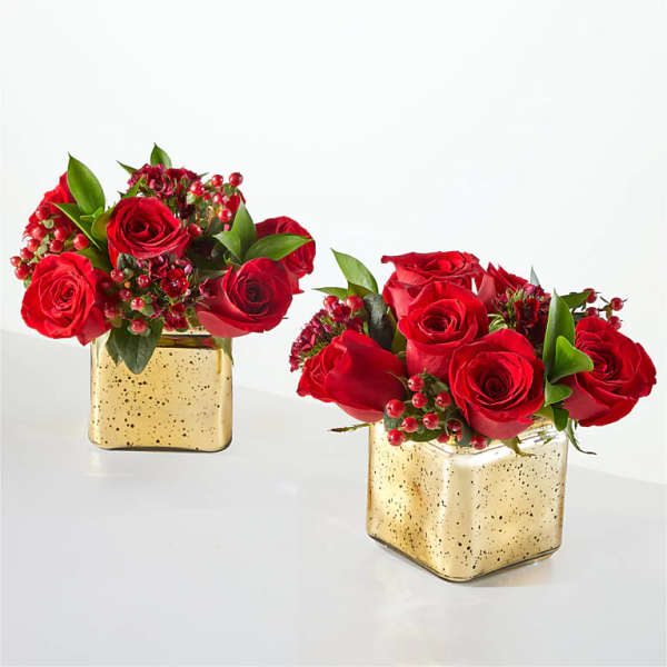 Two red rose arrangements in gold square vases