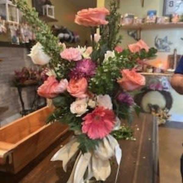 Tall mixed flower arrangement with pink and white blooms in a vase