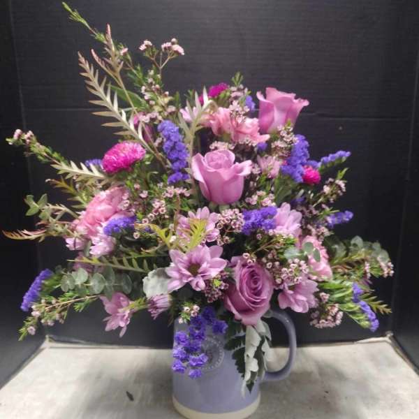 Lavender and pink mixed bouquet in a ceramic pitcher vase