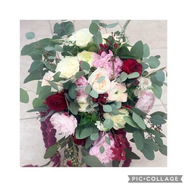 Bouquet of red, pink, and white flowers with eucalyptus foliage