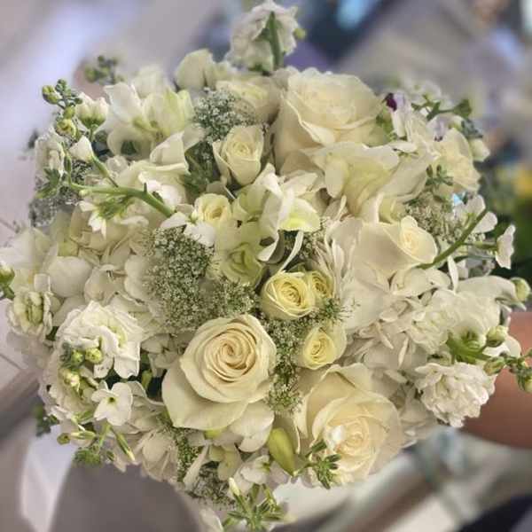 Round bouquet of white roses and white orchids