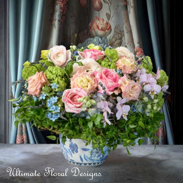 Pastel floral arrangement in a blue-and-white ceramic vase