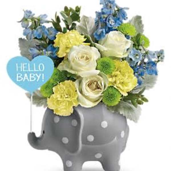 Blue, yellow, and white flowers in a gray elephant vase with a "Hello Baby!" sign