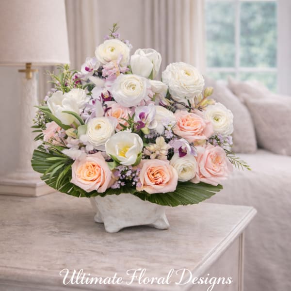 Pastel floral arrangement in a white vase with roses and tulips
