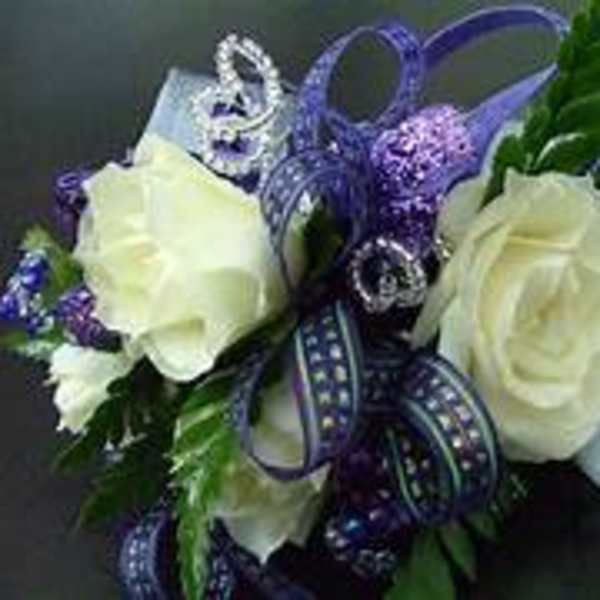 White roses with purple ribbon and silver accents