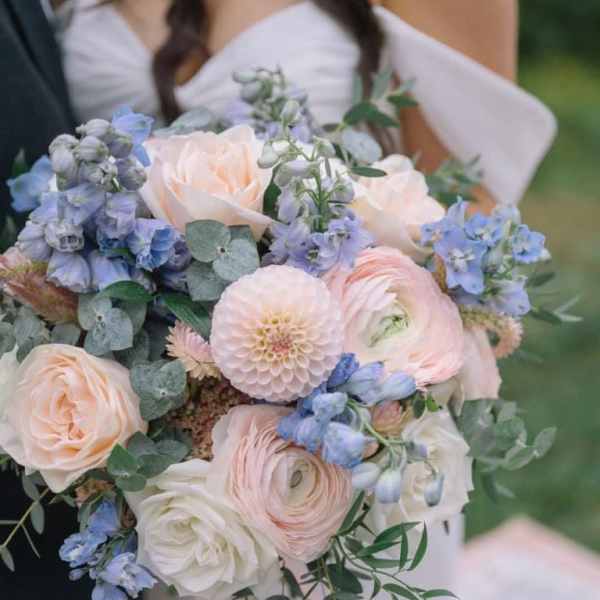 Wedding bouquet of blush, white, and blue flowers