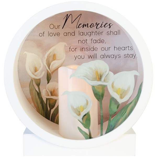 Memorial candle with white calla lilies and a remembrance message