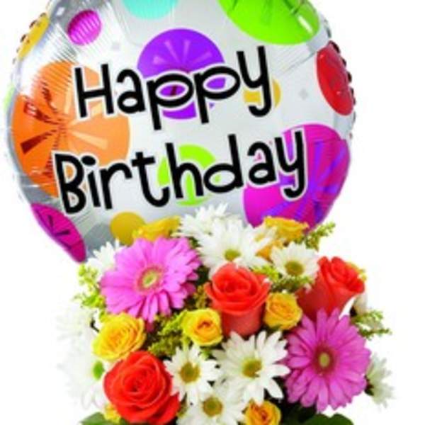 Birthday balloon above a colorful bouquet in a glass vase