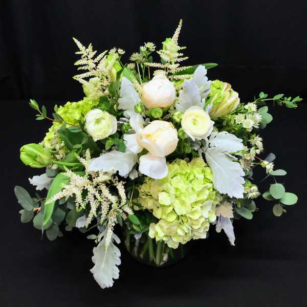Round white centerpiece with soft green grey