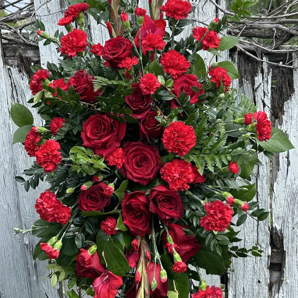 Tall red rose and carnation arrangement with greenery