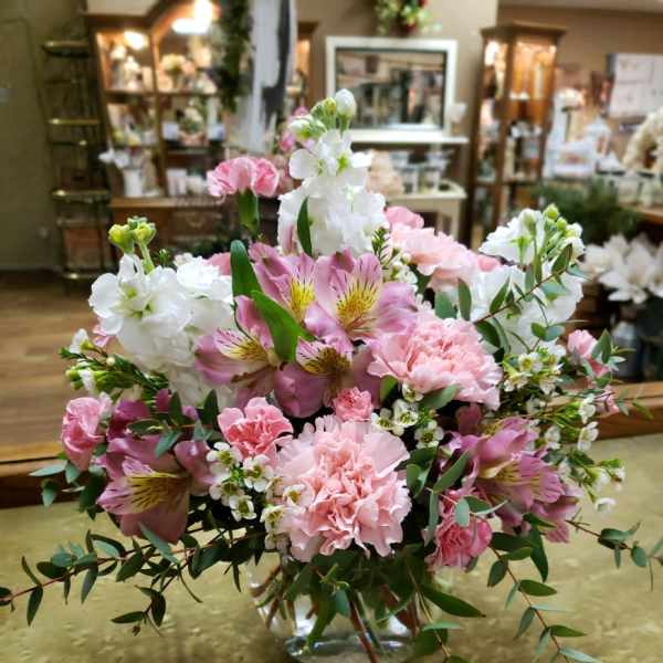 Pink and white floral arrangement in a clear glass vase