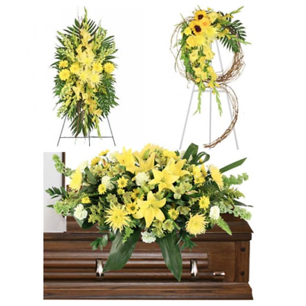 Yellow floral funeral arrangements displayed on and above a casket