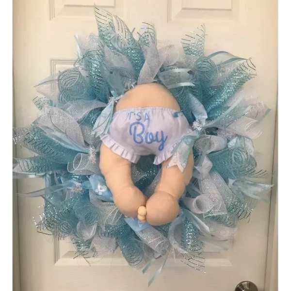 Baby-themed wreath with a doll wearing "It's a Boy" shorts