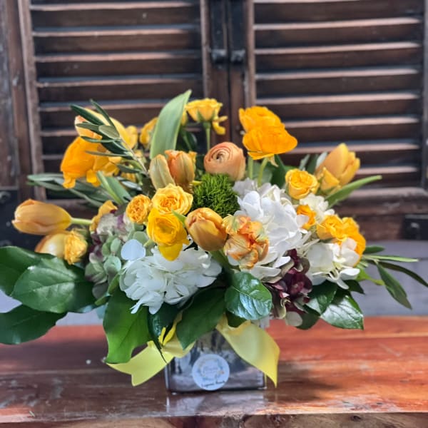 Yellow and white mixed bouquet in a square vase with ribbon