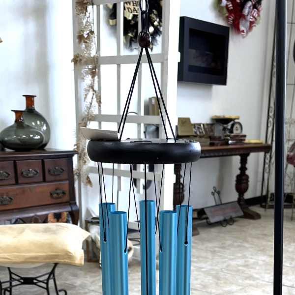 Blue hanging wind chime with black top and clapper