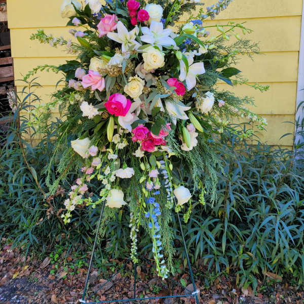 Tall standing floral spray with pink, white, and blue flowers
