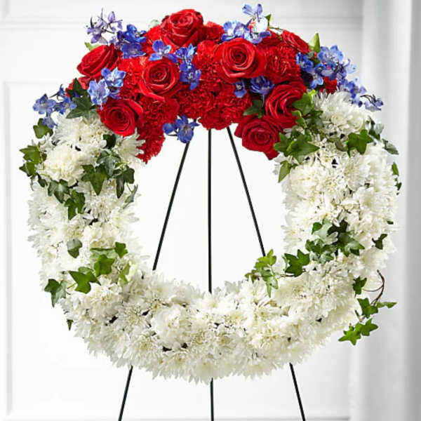 Red, white, and blue floral wreath on a black easel