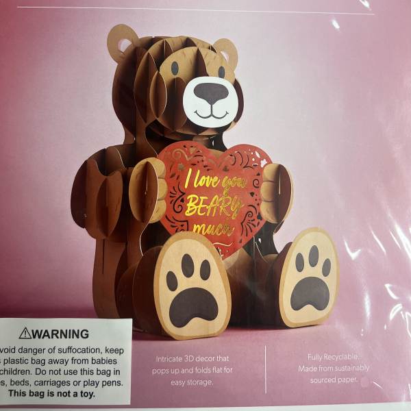 Pink package with a 3D paper bear holding a heart sign