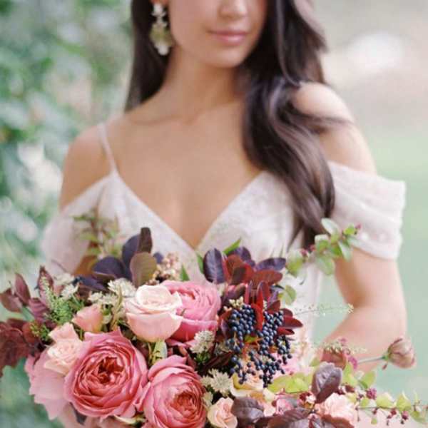 Woman holding a pink and burgundy bridal bouquet