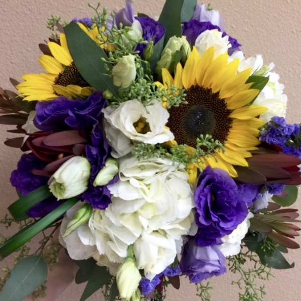 Bouquet of sunflowers, white blooms, and purple flowers
