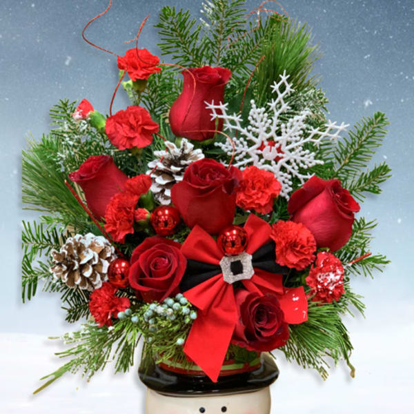 Red roses and carnations in a snowman planter with pinecones and ribbon