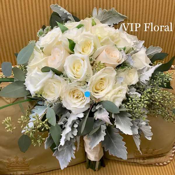 White rose bouquet with silver foliage and green accents