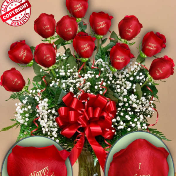 Red roses with baby’s breath in a glass vase and red ribbon