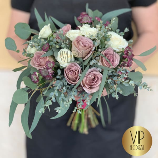 Hand-tied bouquet of blush and white roses with eucalyptus