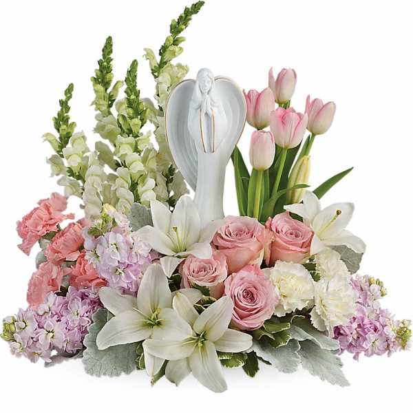 Pink and white floral arrangement with an angel figurine centerpiece