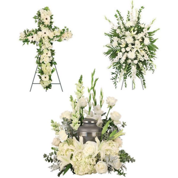 White funeral floral tributes with a cross and urn arrangement
