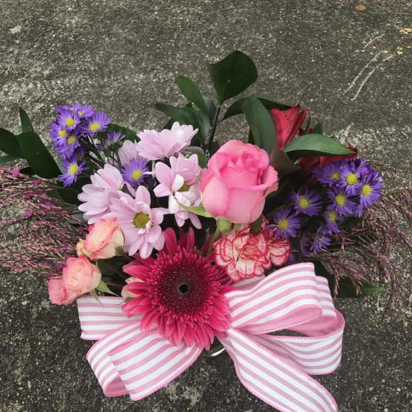 Pink and purple mixed bouquet with a striped ribbon bow