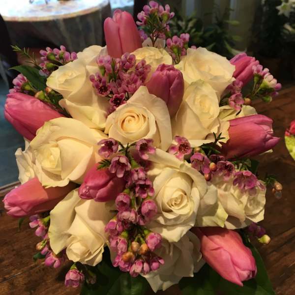 Bouquet of white roses and pink tulips with small pink filler flowers