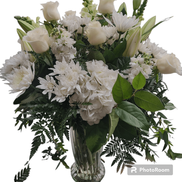 White roses and chrysanthemums in a clear glass vase
