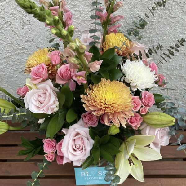 Bouquet of pink roses, chrysanthemums, lilies, and snapdragons