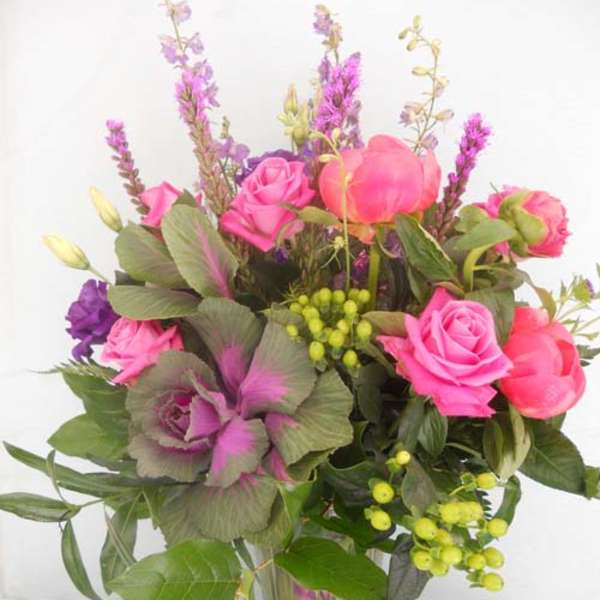 Pink and purple mixed bouquet in a clear glass vase