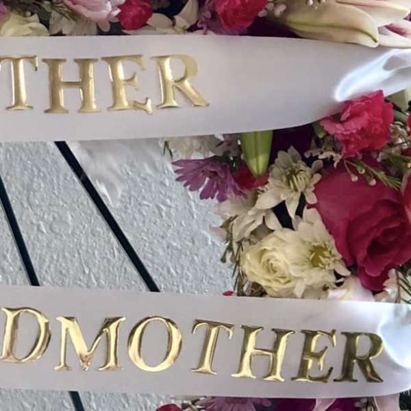 Floral wreath with satin ribbons reading Mother and Grandmother
