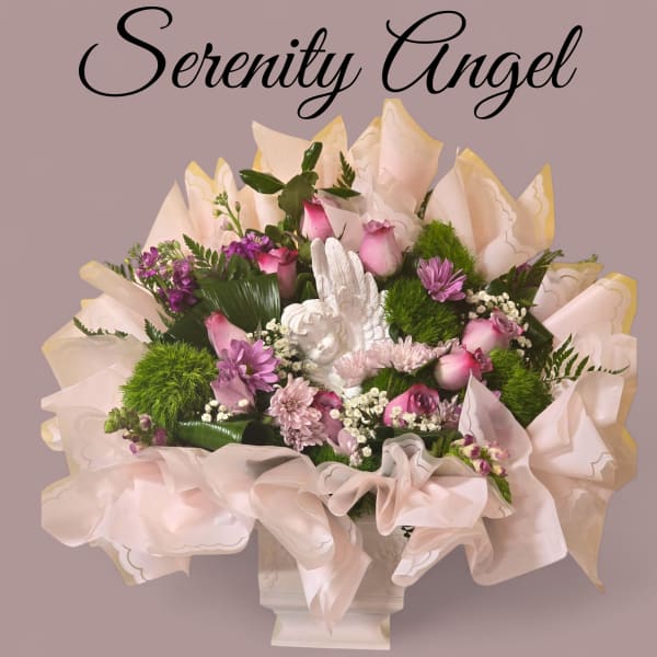 Pink and purple bouquet with an angel figurine in a white vase