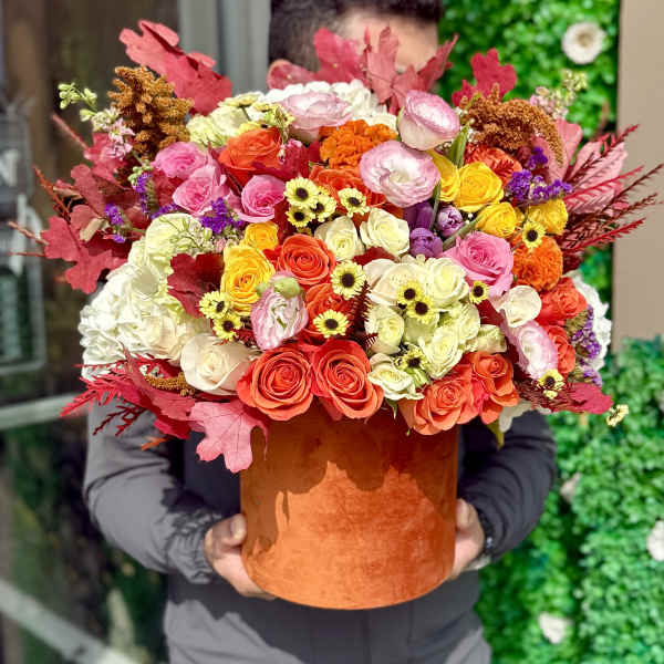 Large mixed bouquet in an orange velvet box with pink, white, and orange flowers