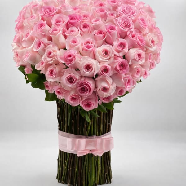 Large bouquet of pink roses tied with a pink ribbon
