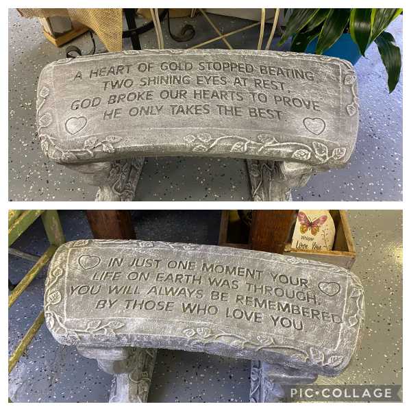 Two stone memorial benches with engraved sympathy messages.