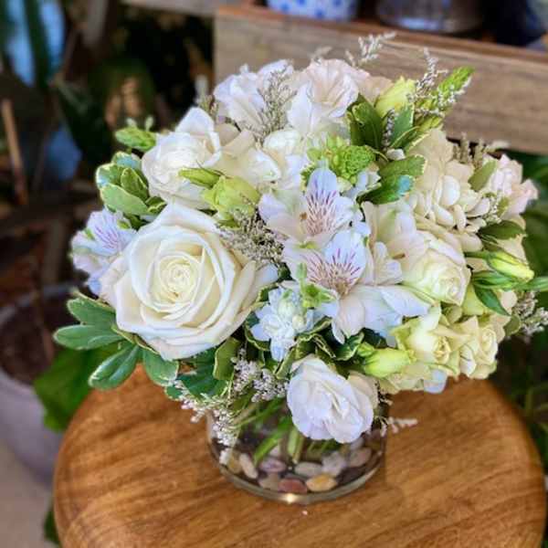 White rose and hydrangea bouquet in a glass vase