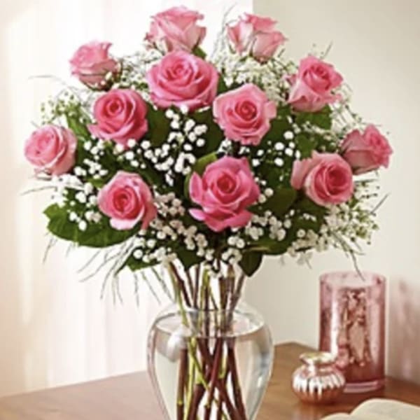 Pink roses arranged in a clear glass vase
