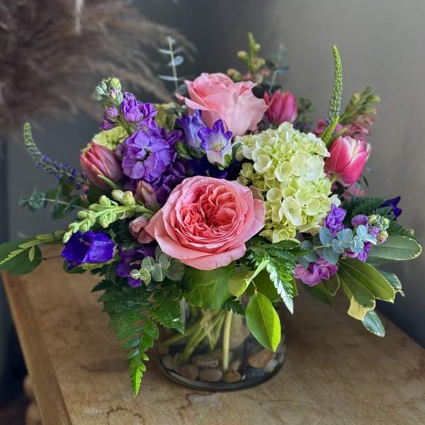 Pink and purple mixed bouquet in a glass vase